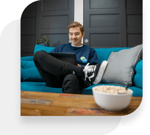 Kimoby employee working comfortably on a couch in the office space.