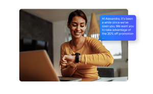 Customer happy about receiving a promotion sent by text message that she is reading on her smart watch