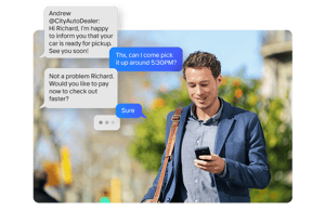 A customer receiving a text message that their car is ready
